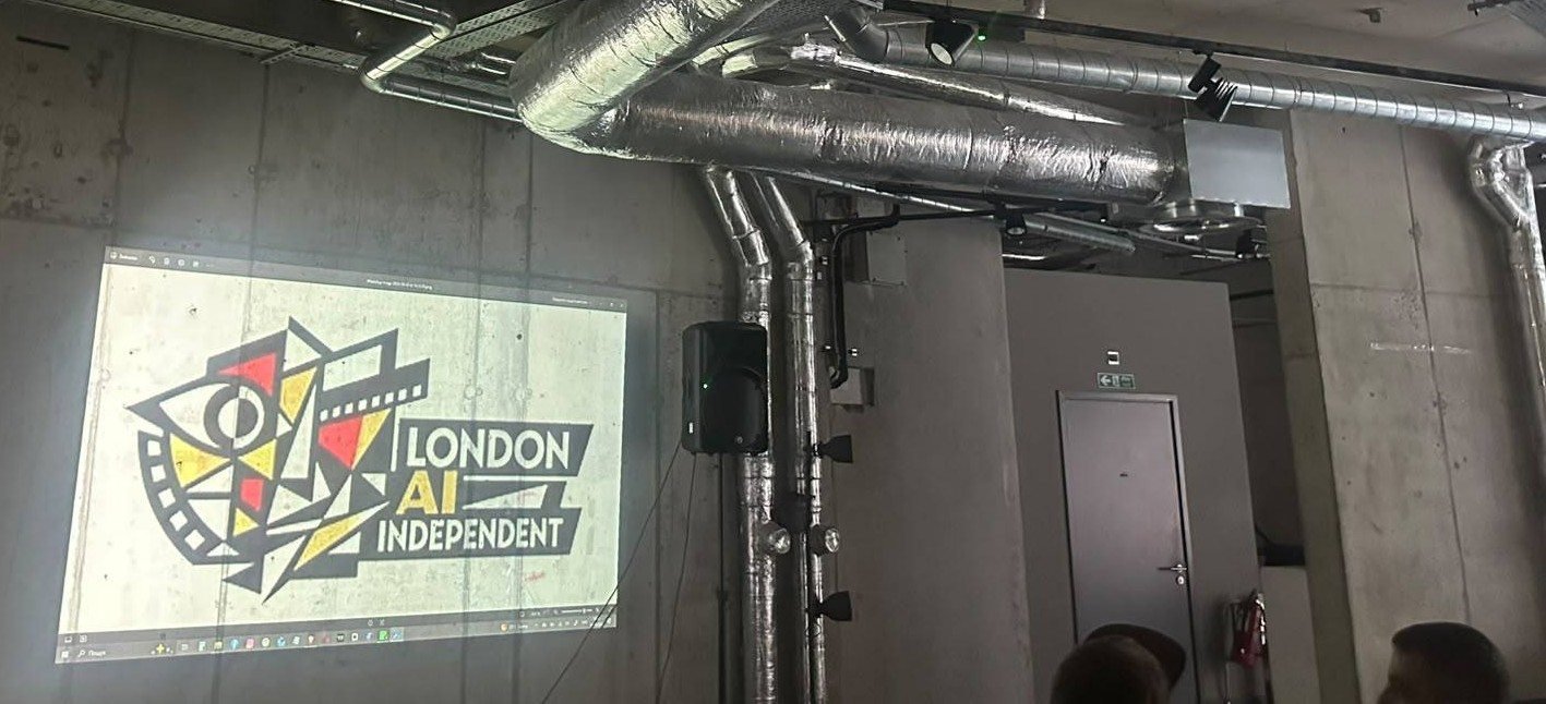 The festival logo on screen in the exposed-concrete screening space, ductwork overhead.